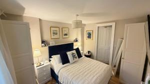 a bedroom with a bed with a blue and white comforter at Georgian House Boutique B&B in Edinburgh