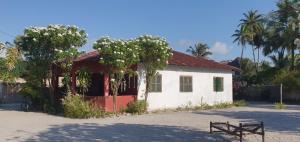 a small white building with a red roof at Jambiani Holiday Villa in Jambiani