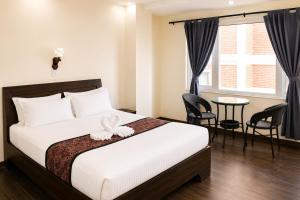 a bedroom with a bed and a table and chairs at Apartment Hotel 11 Thamel in Kathmandu