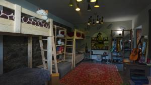 a room with two bunk beds and a guitar at The Kalavan Retreat Center in Chambarak