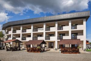 an apartment building with two gazebos in front of it at Kredo in Solotvyno