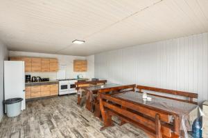 a kitchen with a table and benches in it at Kredo in Solotvyno