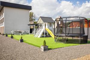 a playground with a slide and a swing at Kredo in Solotvyno