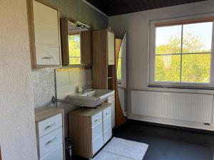 a bathroom with a sink and a window at Apartment Florence in Wettringen