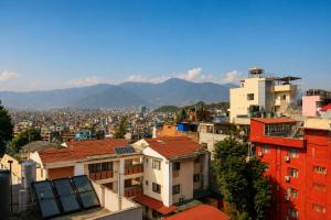 a city with buildings and mountains in the background at Apartment Hotel 11 Thamel in Kathmandu