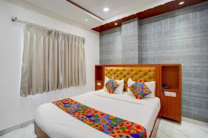 a bedroom with two beds and a window at FabHotel SV Grand I in Varanasi