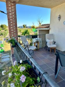 a patio with two chairs and flowers on a balcony at Finca Viña Alberto in Cuéllar