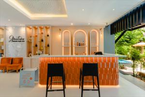 a bar in a store with two chairs in front of it at Aree Tara Ao Nang Krabi in Ao Nang Beach