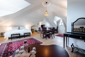 a bedroom with a bed and a dining room at BeGuest Estoril Guesthouse in Estoril