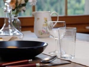 a table with a bowl and a glass of water at Apartment Chalet l'Aube by Interhome in Vers L'Eglise