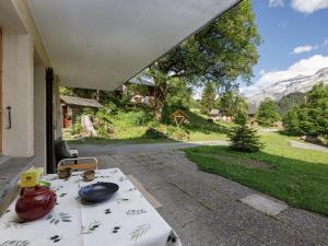 a table with a tea pot sitting on a patio at Apartment Chalet l'Aube by Interhome in Vers L'Eglise