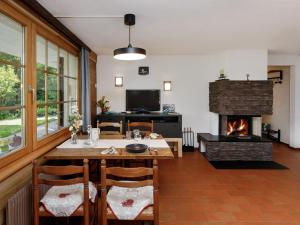 a dining room with a table and a fireplace at Apartment Chalet l'Aube by Interhome in Vers L'Eglise +23 photos