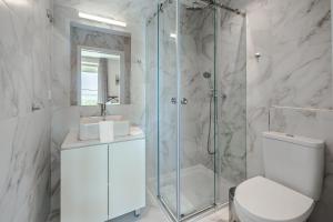 a bathroom with a shower and a toilet and a sink at BeGuest Estoril Guesthouse in Estoril +83 photos