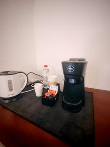 a coffee maker sitting on top of a table at Guesthouse La Locanda - Comfy Rooms & Local Food in Porto San Paolo