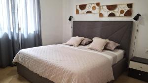 a bedroom with a large bed with two pillows at Holiday Home Petra in Podstrana +63 photos