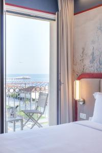 a bedroom with a bed and a view of the ocean at Vi Place in Lido di Camaiore +81 photos