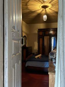 an open door to a bedroom with a bed at Dadu Guest house in Davberi