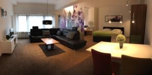 a living room with a couch and a bed at Gästehaus beim Prinz in Kürten