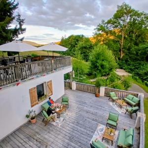 a man sitting on the deck of a house at VATTERSGARDEN GmbH in Viechtach