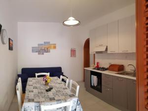 a kitchen with a table with chairs and a dining room at Casa Nespolo in San Vito lo Capo