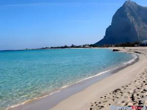 a view of a beach with a mountain in the background at Casa Nespolo in San Vito lo Capo