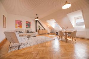 a living room with a table and chairs at KUKI Apartments in Trenčín