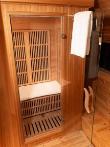 a wooden sauna with a glass door in a bathroom at Domaine Arvor & Spa in Lanvallay +107 photos