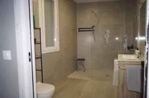 a bathroom with a shower and a toilet and a sink at Casa Rural El Capricho in Casas del Monte +30 photos
