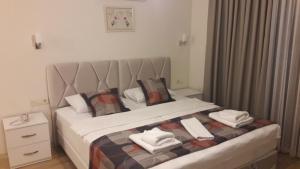a bedroom with a bed with towels on it at Süreyya Hanım Otel in İzmir