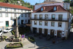 a large white building with a fountain in front of it at SeiaVilla - São Pedro in Seia