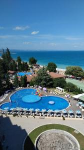 an overhead view of a pool with chairs and umbrellas at Golden Sands Apartments Zlatna Kotva in Golden Sands