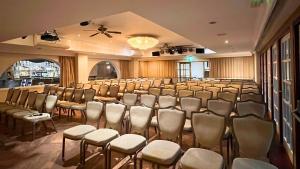 a large room with a bunch of chairs in it at Santo's Higham Farm Hotel in Alfreton