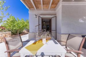 a white table and chairs on a patio at Masseria Prisuti in Punta Prosciutto
