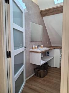 a bathroom with a sink and a mirror at NORDIQUES DE LA WELCHE in Orbey +61 photos