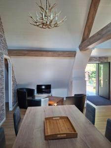 a dining room with a wooden table and chairs at NORDIQUES DE LA WELCHE in Orbey