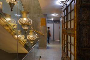 a hallway with several chandeliers on display in a store at Casa da Praça - Alojamento Local in Sesimbra +89 photos