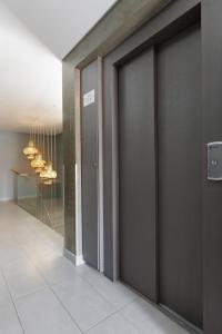 a hallway with sliding doors in a building at Casa da Praça - Alojamento Local in Sesimbra