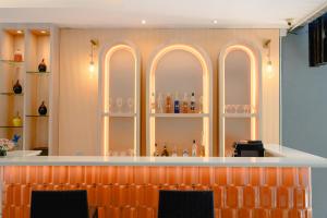 a bar with arched windows and bottles on display at Aree Tara Ao Nang Krabi in Ao Nang Beach