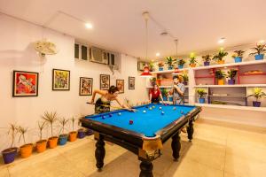 a group of people playing pool in a room with plants at goSTOPS Jaipur, Civil Lines in Jaipur