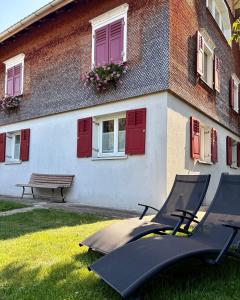 a building with a bench in front of it at Ferienwohnung Lauterach in Lauterach