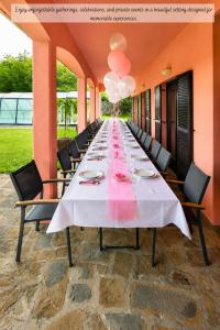 a long table with chairs and a long table at Villa Noiram - Your dream Getaway in Nature in Senožeče