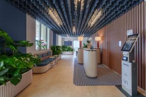 a lobby with potted plants on the walls at Vi Place in Lido di Camaiore