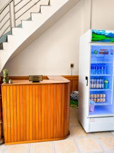 a refrigerator with drinks in it next to a staircase at Linh Chi Hotel in Mù Cang Chải