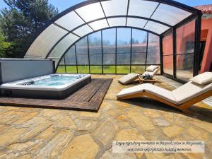 a hot tub in a gazebo on a patio at Villa Noiram - Your dream Getaway in Nature in Senožeče