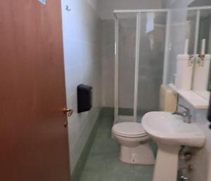 a bathroom with a toilet and a sink at Desdemona House Pub in Castellino Tanaro +18 photos