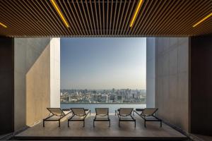 a group of chairs in a room with a view at Eastin Grand Hotel Phayathai in Bangkok