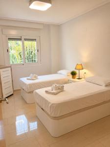 a bedroom with two beds and a window at Villa La Perla - Pool, Garden & Barbecue - AC in Mutxamel +70 photos