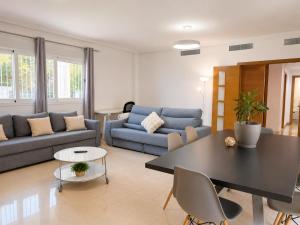 a living room with a couch and a table at Villa La Perla - Pool, Garden & Barbecue - AC in Mutxamel