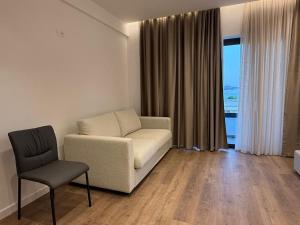 a living room with a couch and a chair at Riviera Central Escape in Sarandë