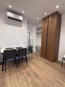 a room with a table and chairs and a cabinet at Riviera Central Escape in Sarandë